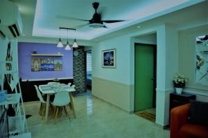 a dining room and living room with a table and chairs at Awedee Homestay Putrajaya in Putrajaya
