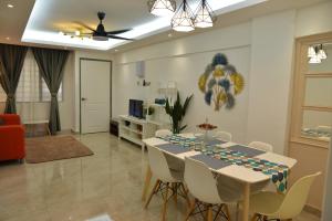 a living room with a dining room table and chairs at Awedee Homestay Putrajaya in Putrajaya