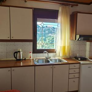 A kitchen or kitchenette at Anilio Rooms