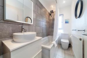 bagno bianco con lavandino e servizi igienici di Trendy Spacious 2BR apt near London Bridge a Londra