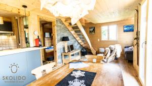 a living room with a staircase in a tiny house at Chalet Eichhornli, Riederalp Golmenegg in Riederalp