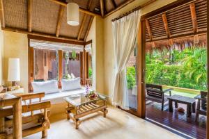 a living room with a couch and a table at High Season Pool Villa & Spa in Ko Kood