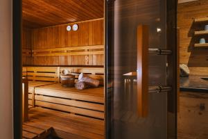 a sauna with wooden walls and a wooden floor at Hotel Flachauerhof in Flachau
