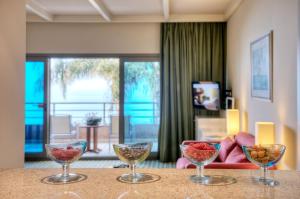 4 copas de vino sentadas en una mesa en una sala de estar en Le Royal Hotel - Beirut, en Beirut