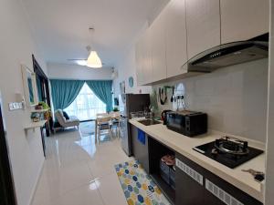 a kitchen with a sink and a stove top oven at COZY home Country Garden at DangaBay of JB, FREE wifi and streaming in Johor Bahru
