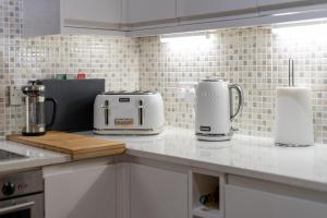 a kitchen with two toasters on a counter top at Stunning Central 2BR Flat btw Soho & Covent Garden in London