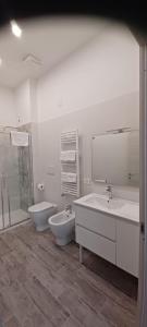 a bathroom with two sinks and a toilet and a shower at CARLO DI BORBONE - Casa Vacanze- in Fornelli