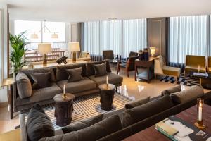 a large living room with couches and chairs at Radisson Blu Edwardian Bond Street Hotel, London in London