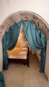 Un ou plusieurs lits dans un hébergement de l'établissement Locazione turistica il boschetto