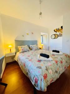 a bedroom with a bed with two pillows on it at A Alma Portuguesa in Fátima