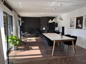 a dining room and living room with a table and chairs at Villa - Stilvolles Boutique Landhaus in Grömitz