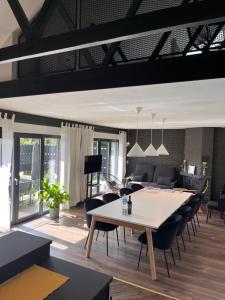 a living room with a table and chairs at Villa - Stilvolles Boutique Landhaus in Grömitz