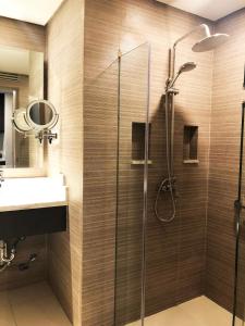 a bathroom with a shower and a sink at The Residences at BCCT in Manila