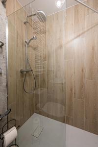 a bathroom with a shower with a glass door at Apartament Crab Sopot Kamienny Potok in Sopot