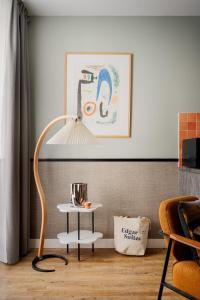 a lamp in a living room with a table at Edgar Suites Saint-Lazare - Amsterdam in Paris