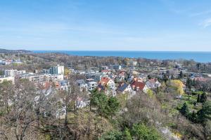 a city with buildings and the ocean in the background at Apartament Crab Sopot Kamienny Potok in Sopot