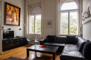 a living room with a couch and a coffee table at d.Five Döbrentei Apartment in Budapest