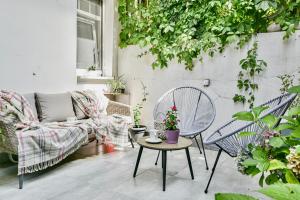 a patio with a couch and a table and chairs at Buda Bliss Garden in Budapest