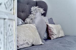 a pile of pillows on a bed next to a wall at Buda Bliss Garden in Budapest