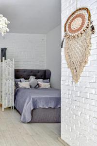 a bedroom with a bed against a white brick wall at Buda Bliss Garden in Budapest