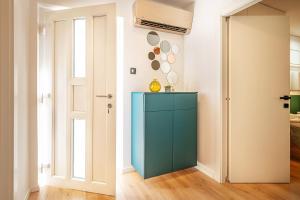 a room with a blue cabinet and a door at Apartment Noa Malinska in Vantačići +13 photos