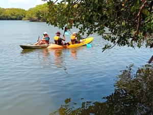 a group of people in kayaks on a lake at Gange Wadi Wilpattu in Gangewadiya