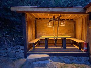 a wooden picnic table in a pavilion at night at Isabellental - Blacksmithing in Stříbro