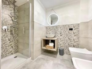 a bathroom with a shower and a toilet and a sink at Regina Elena Rooms in Pescara