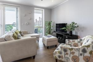 a living room with two couches and a tv at Lovely 3 beds Penthouse in London