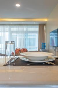 a table with two plates and a glass on it at Roma Court Serviced Apartments in Nairobi