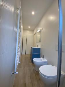a bathroom with a toilet and a sink at Casettadellafotografia in Senigallia +12 photos