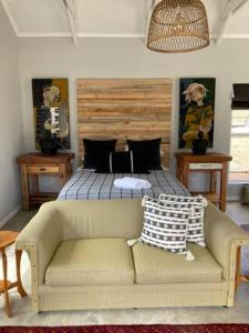 a bedroom with a bed and a couch and a bed at Joubertsdal Country Estate in Swellendam