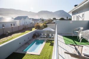 a view from the balcony of a house with a swimming pool at The Whale on Main B&B in Hermanus