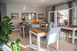 a dining room with tables and chairs and a dining room at The Whale on Main B&B in Hermanus