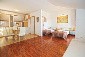 a living room with a bed and a dining room at Apartmani Niki Hvar in Hvar