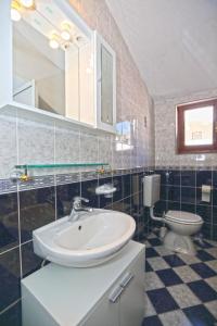 a bathroom with a sink and a toilet at Apartmani Niki Hvar in Hvar