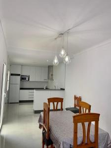 a kitchen with a table and chairs and a kitchen with white cabinets at EL SOL ANDALUZ - CASA GOYA in Carboneras +19 photos