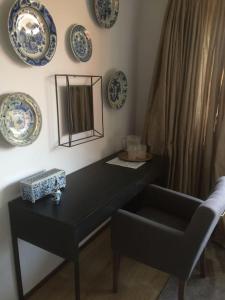 a black table with a chair and plates on the wall at Near Amsterdam and airport, 90m2, privacy! in Hoofddorp