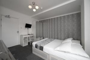 Postel nebo postele na pokoji v ubytování Flexistay Tulsi Aparthotel