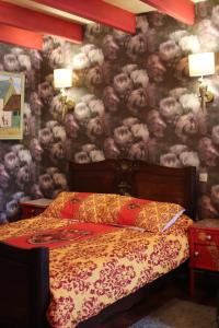 a bedroom with a bed and a wall covered in smoke at La Petite Bérais in Missillac +20 photos