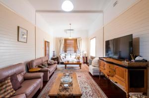 a living room with a couch and a flat screen tv at Ithaca in Grafton