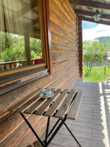a bench on the side of a building with a window at Золото Карпат in Izki +20 photos