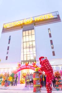 a giant santa claus in front of a building at OYO 1192 Victory Hotel Dien Ban in Danang
