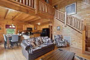 a living room with a couch and a table in a cabin at Amazing Grace #264 in Pigeon Forge