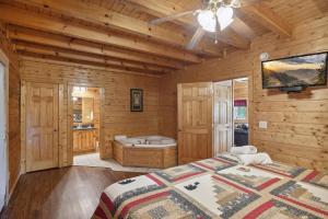 a log cabin bedroom with a bed and a tub at Amazing Grace #264 in Pigeon Forge
