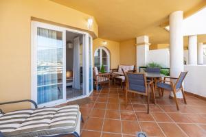 a balcony with a table and chairs and a patio at Señorio de Aloha in Puerto Banus in Marbella