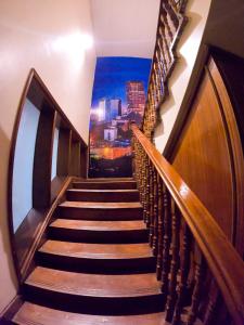 a stairway with a mural of a city at Nairobi Backpackers Hostel in Nairobi
