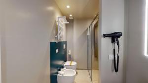 a bathroom with two toilets and a hair dryer at DIVA HOTEL LIGNANO - Adults Only in Lignano Sabbiadoro +74 photos