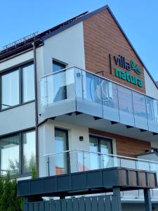 a building with a balcony with a wildlife institute sign on it at Villa Natura Rewa in Rewa