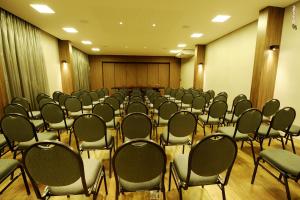 a conference room with rows of chairs in it at Regente Hotel in Unaí